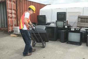 Recycling Worker Moving CRT Televisions